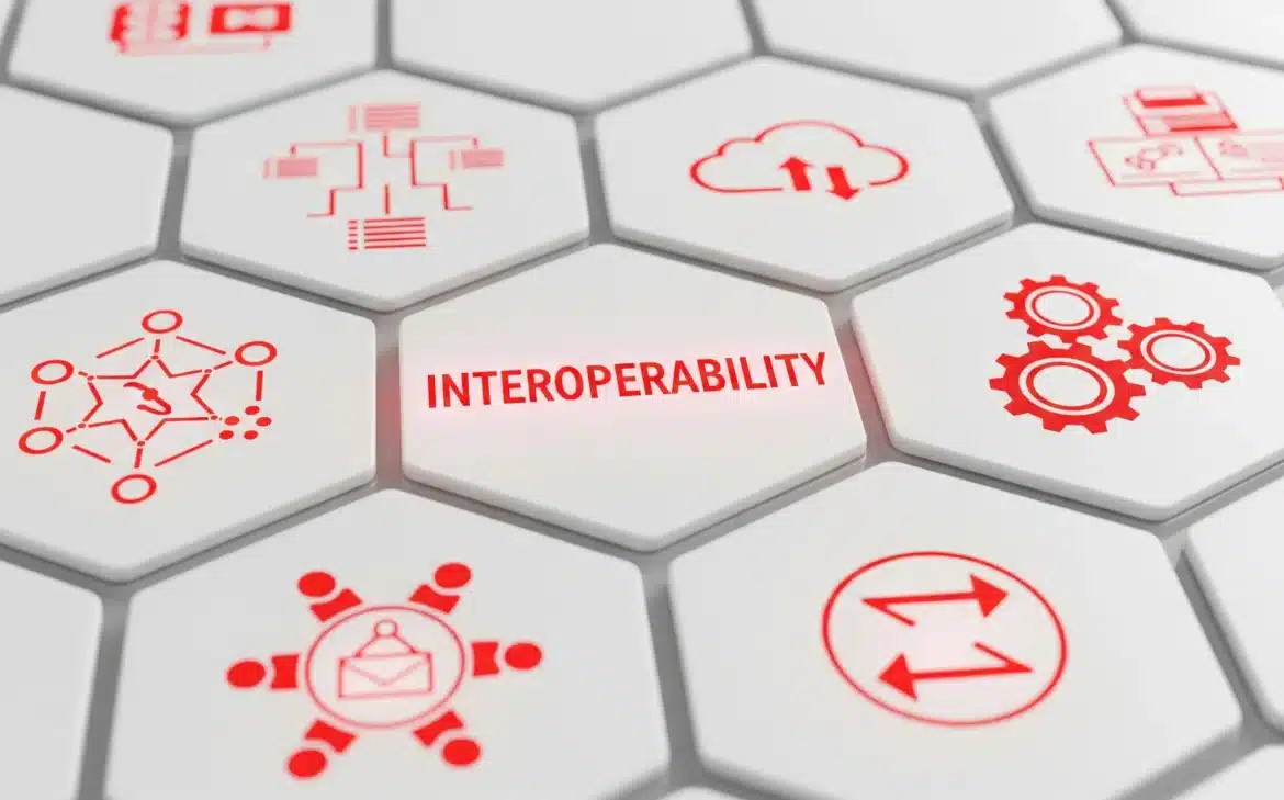 Red icons on a white hexagon depict interoperability concepts, highlighting advancements in healthcare connectivity.